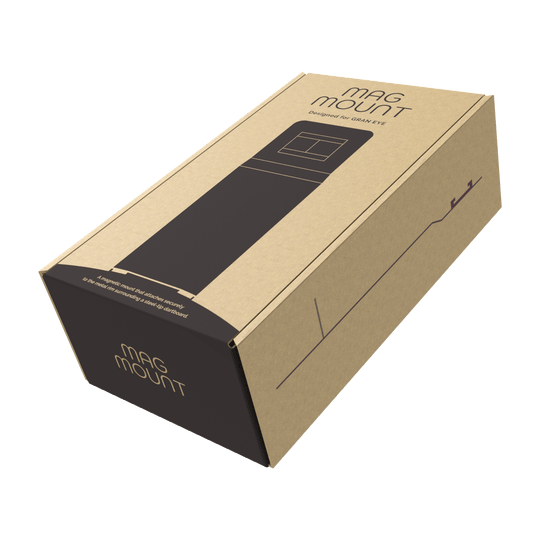 Accesorio de montaje para cargador GranDarts Gran Eye Die Abbildung zeigt eine Verpackung des Produkts "GranDarts GranEye Mag Mount Befestigung". Die Schachtel ist aus braunem Karton und trägt die Aufschrift "Mag Mount".
