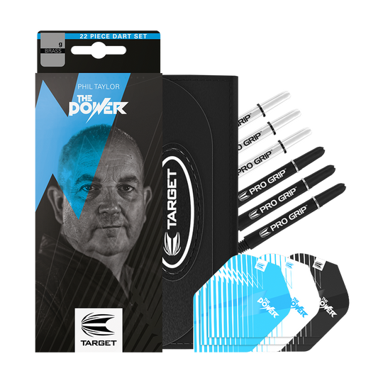 170003_Target_Phil_Taylor_Brass_Steeldarts_3VHFC4VE4ICOeK Das Bild zeigt das Produkt "Target Phil Taylor Brass Steeldarts - 22g" mit Zubehörteilen wie Flights und Shafts. Auf der Verpackung ist ein Porträt von Phil Taylor sowie das Logo von Target abgebildet.